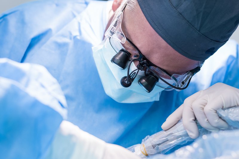 A dentist preforming a dental implant in Kelowna